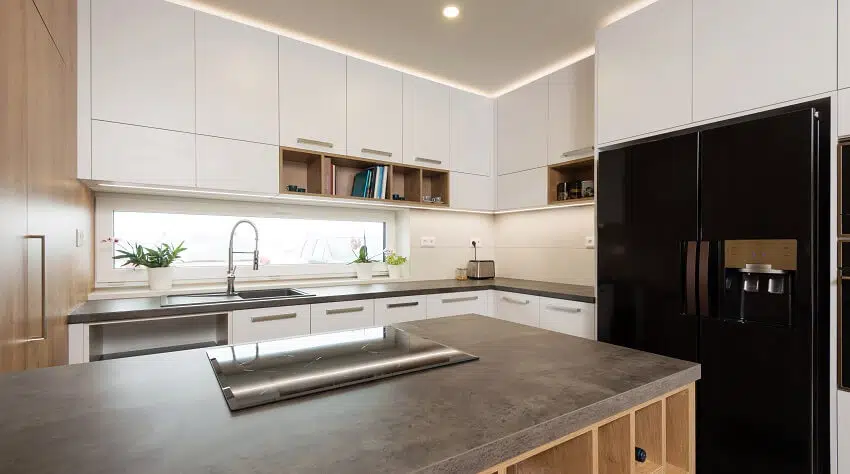 Modern Kitchen With Built In Black Appliances And Island With Laminate Countertop Cooktop And Shelves Is .webp