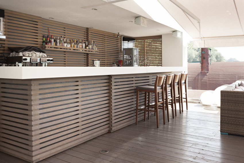 Outdoor area with bar, high chairs, and wood flooring