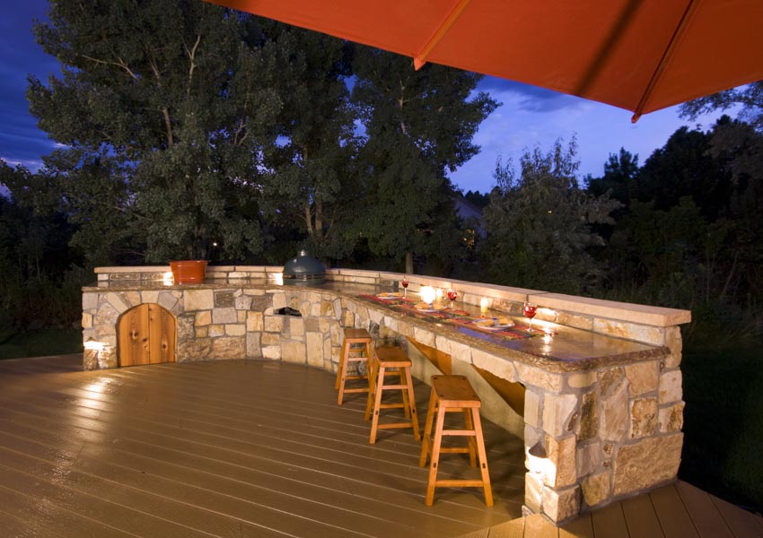 Outdoor area with dining area, countertop, stools, and wood flooring