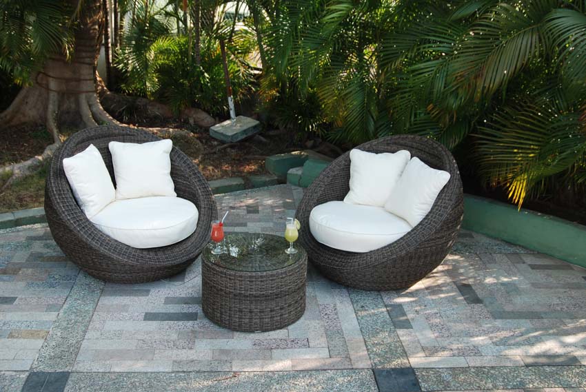 Wicker lounge chairs, coffee table, and pillows
