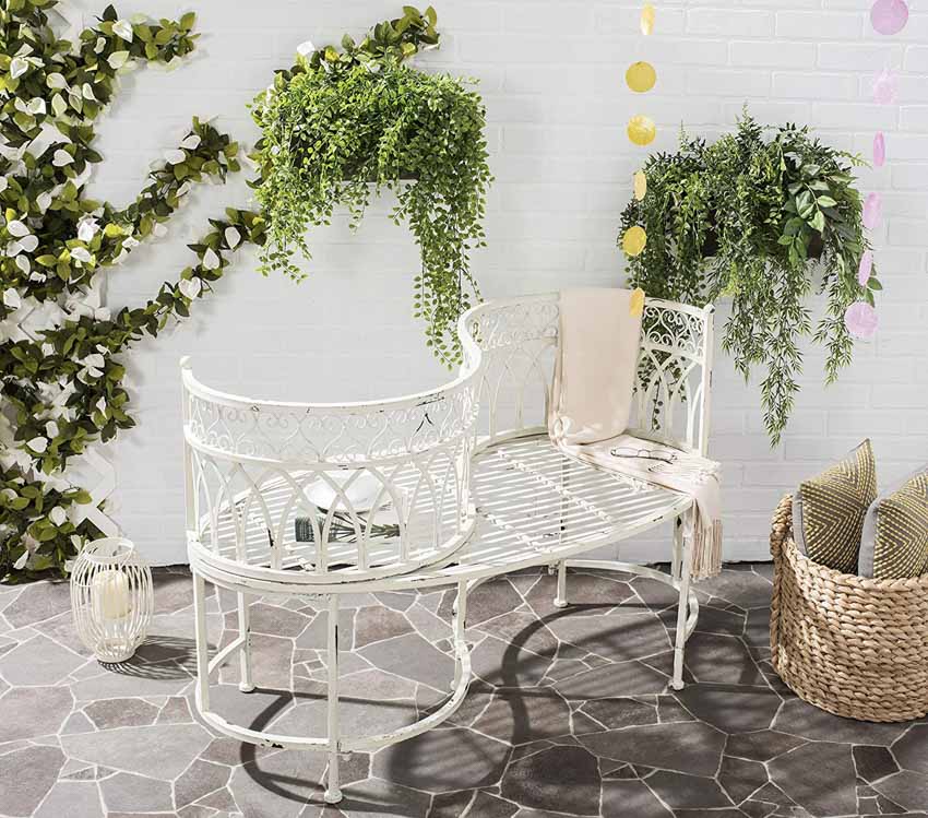 Outdoor area with metal tête à tête chair and plants