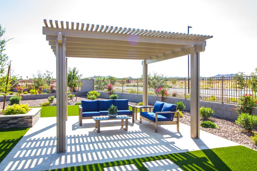 Outdoor area with pergola, couches, and tables