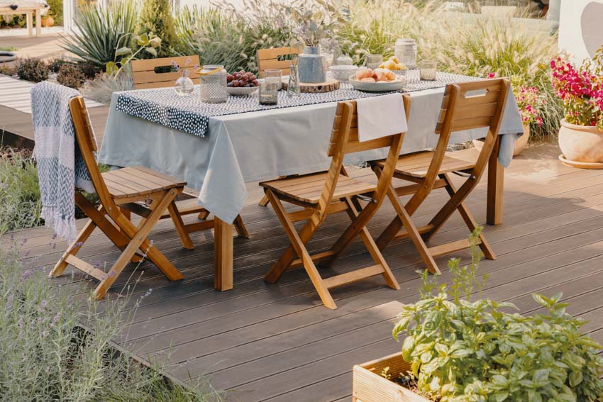 Outdoor deck with dining table, and wooden chairs