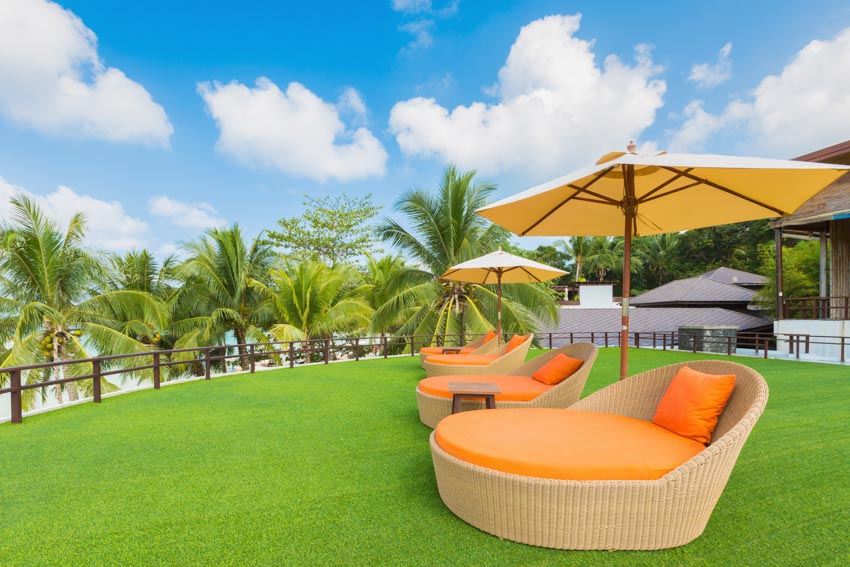 Outdoor lawn with daybed, and umbrella shade