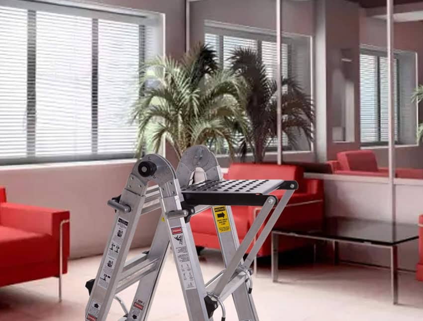 Platform type of ladder inside a room with windows and red chairs