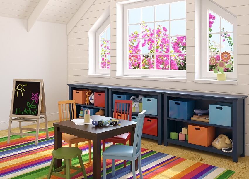 Playroom with paneled ceiling and walls blue shelf storage and a colorful carpet