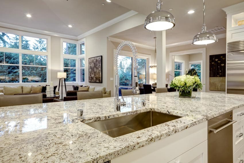 Sealed granite countertop in a kitchen with pendant lights, windows, and recessed lighting fixtures