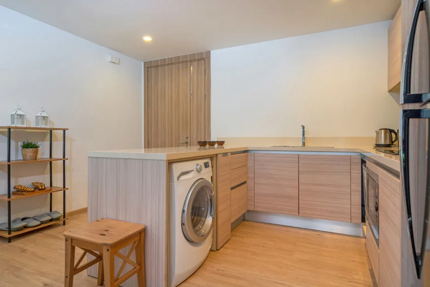 Small kitchen with countertop, cabinets, and laundry machine