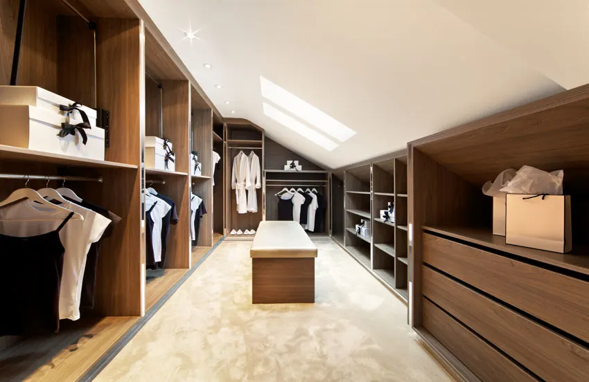 Walk-in closet with skylight window and upholstered bench