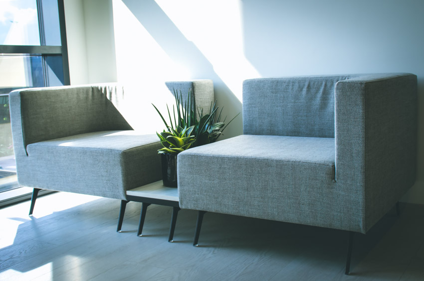 Tête à tête chairs with cushion and indoor plants