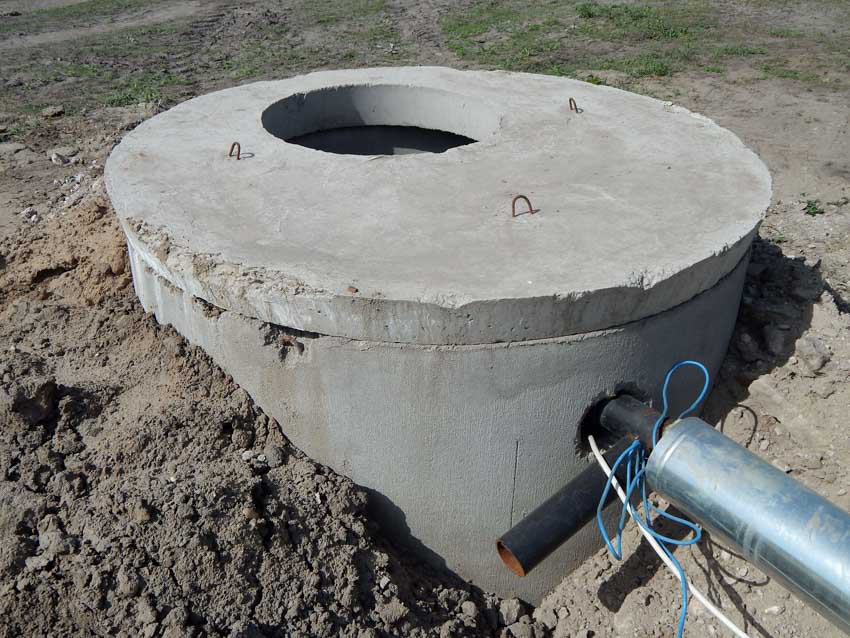 Well with concrete construction connected to a house