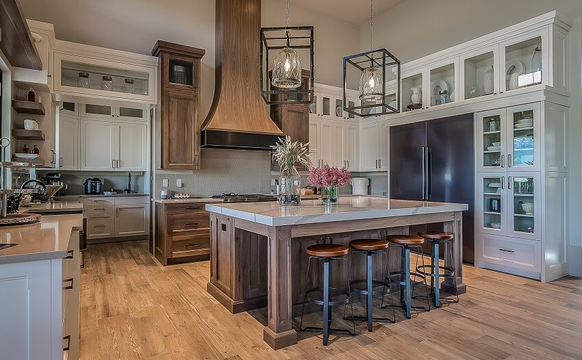 Wood themed custom kitchen with tile backsplash, and island with marble countertop and stools