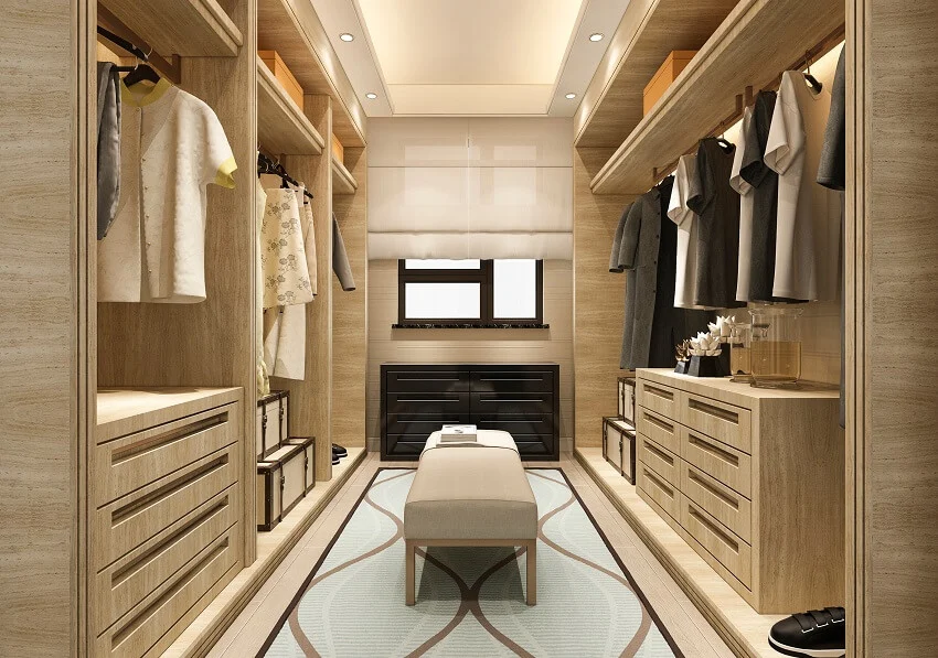 Wood walk-in closet shaded window, carpet, wardrobe, and bench seating