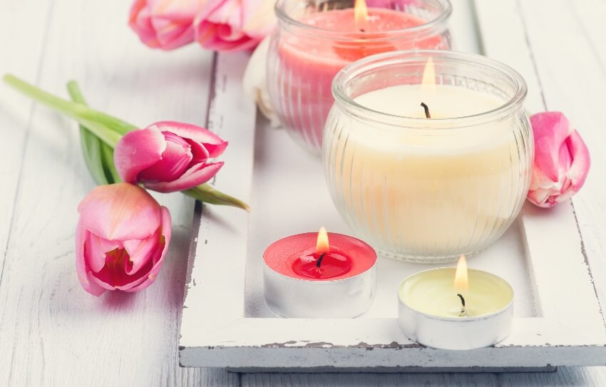 Yellow and pink floral scented candles with tulips in wooden box