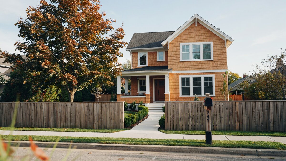 Beautiful home with a wood perimeter fence along the front property line
