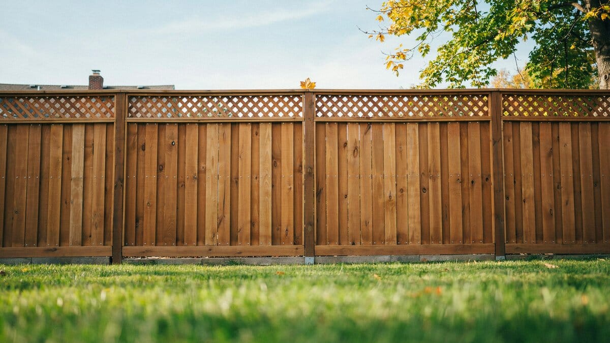 Cedar wood privacy fence topped with a decorative lattice panel