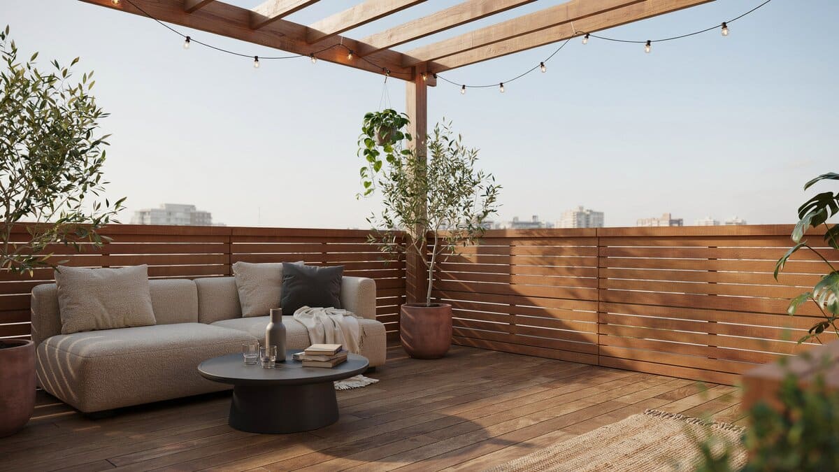 Rooftop patio enclosed by a horizontal wood slat fence with a shade pergola