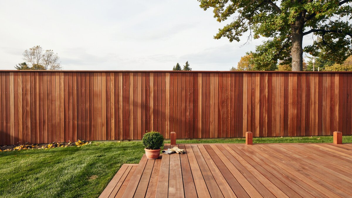Redwood privacy fence enclosing a raised wood deck