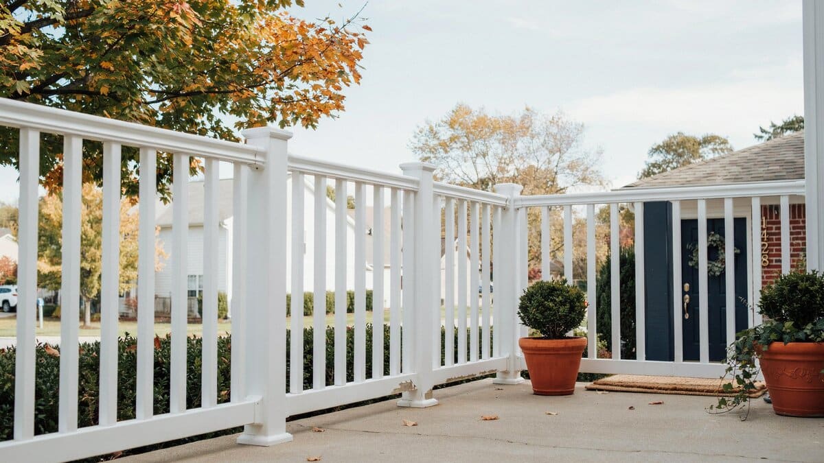 White wood railing fence around a front porch of a home