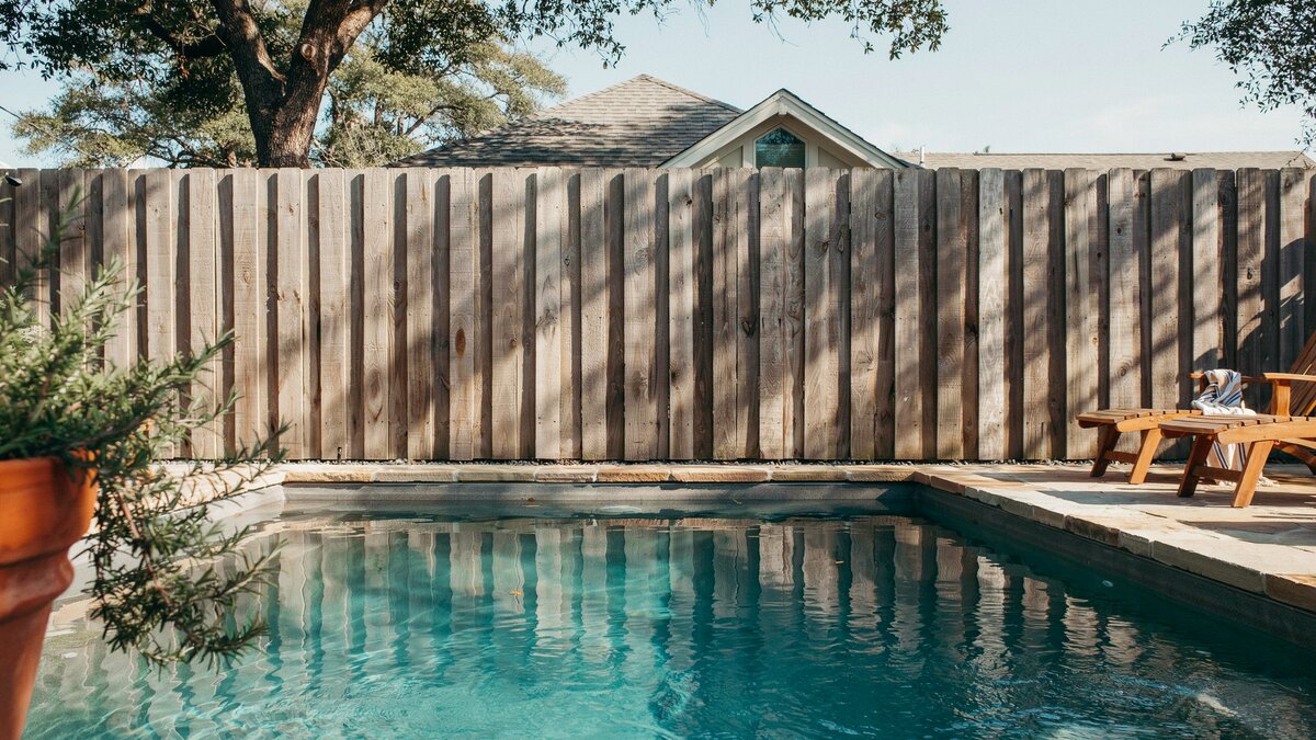 Wood privacy fence screening a poolside cabana