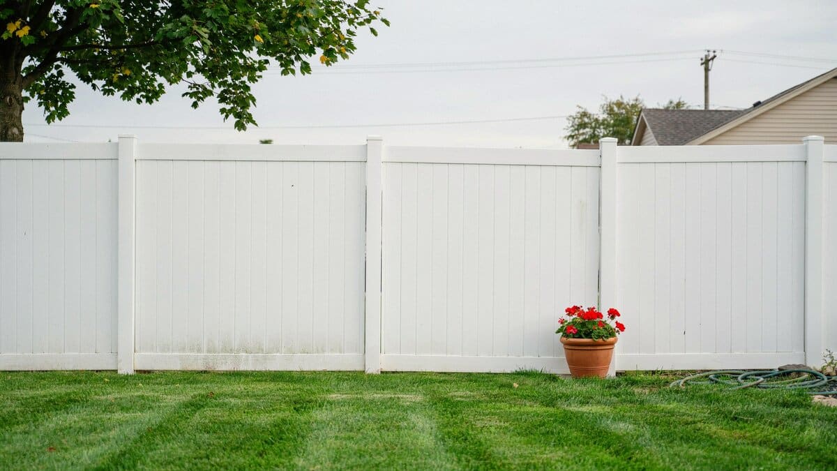 White PVC fence enclosing a residential yard