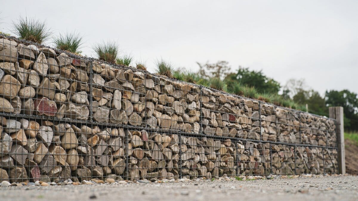 Gabion fence made of wire cages filled with stones