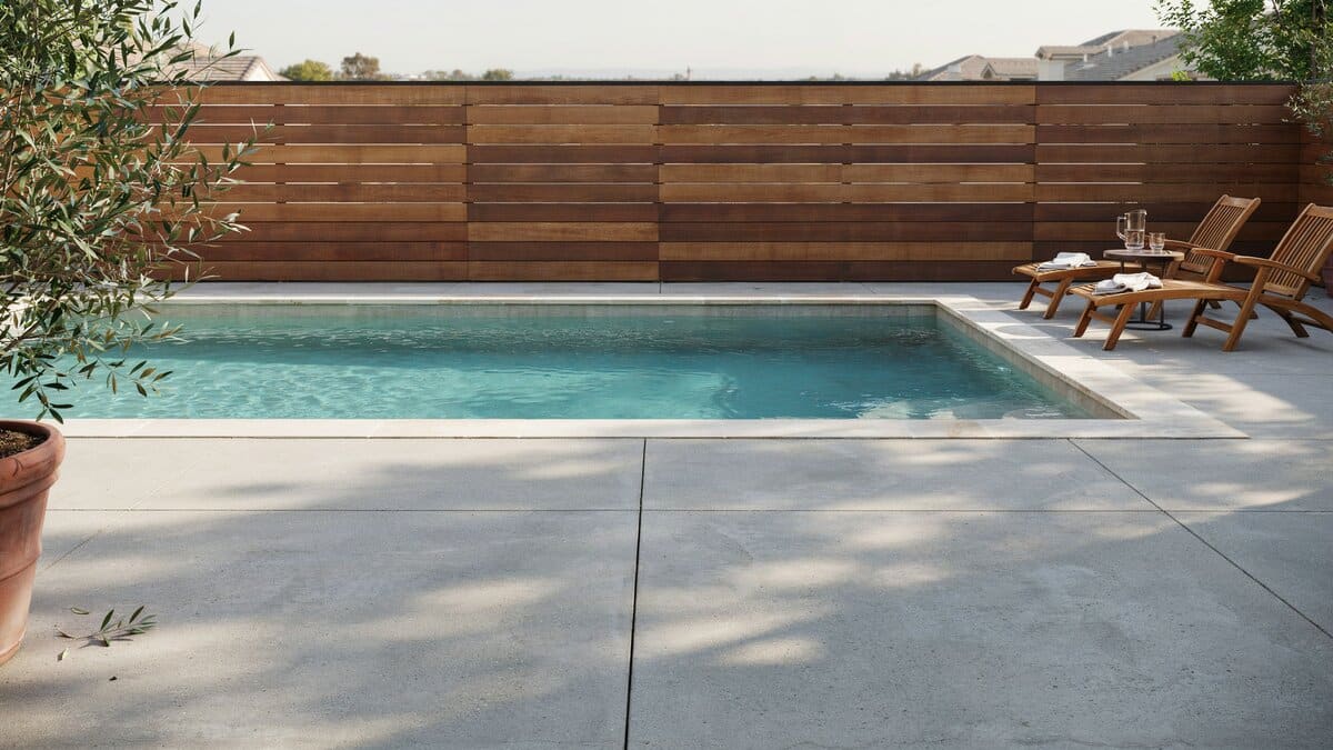 Horizontal wood slat privacy fence surrounding a swimming pool
