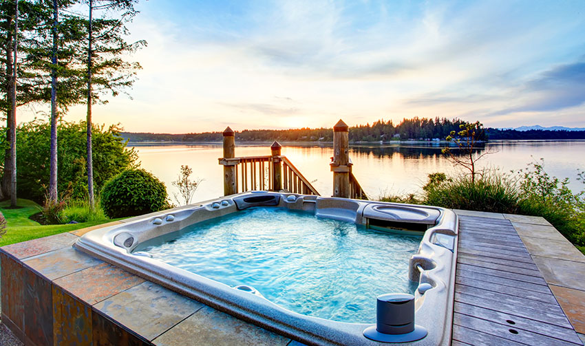 Backyard with tub and access to the lake