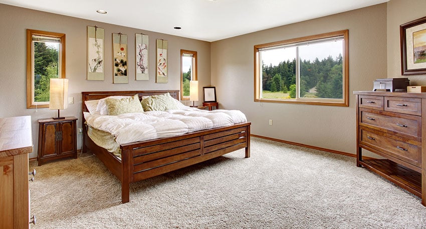 Bedroom with carpet flooring side tables with lampshade beige paint