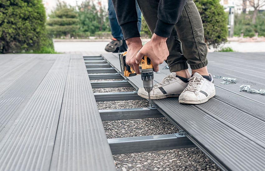 Man installing composite deck boards installation