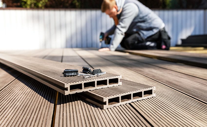 Man installing composite deck boards