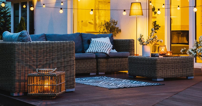 Patio with rattan sofa and rattan coffee table outdoor series lights freestanding lampshade
