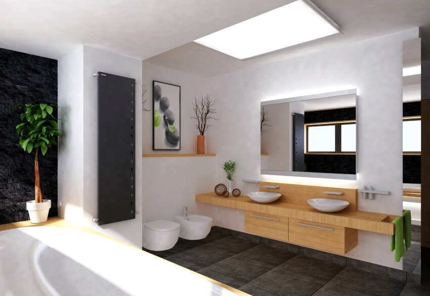 A modern bathroom with butcher block countertops and a black tile floor