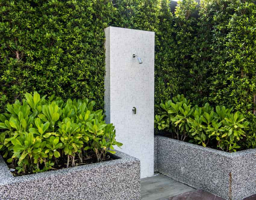 Shower strategically placed between two plant boxes