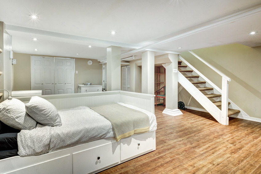 Bedroom in basement with wood floor, and ceiling lights