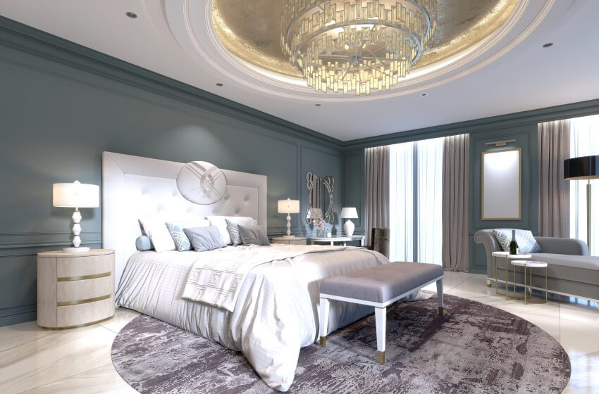 Bedroom with a large white bed, dark walls, light furniture, chandelier, and white marble floor