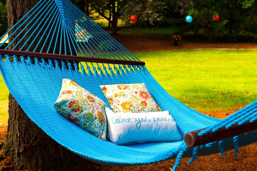 Blue outdoor quilted hammock with pillows
