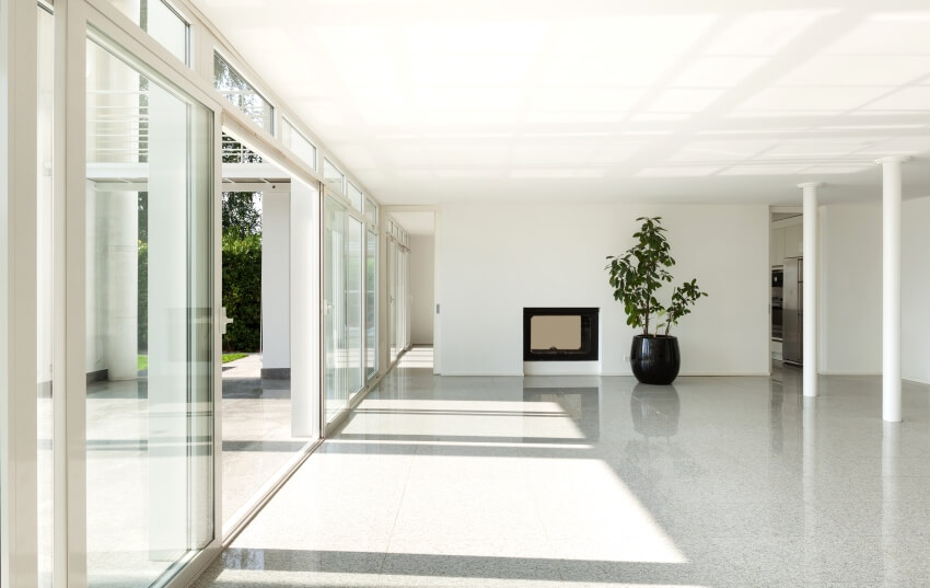 Bright interior of a modern house with columns, polyacrylate terrazzo floor, and glass sliding doors