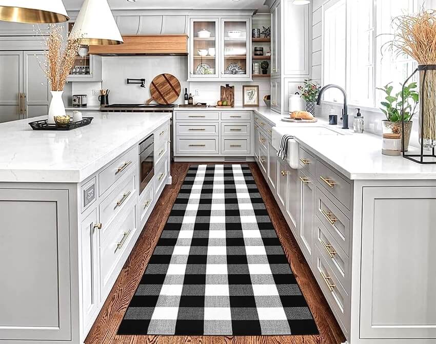 Buffalo plaid check carpet runner on a wood floor of a white kitchen