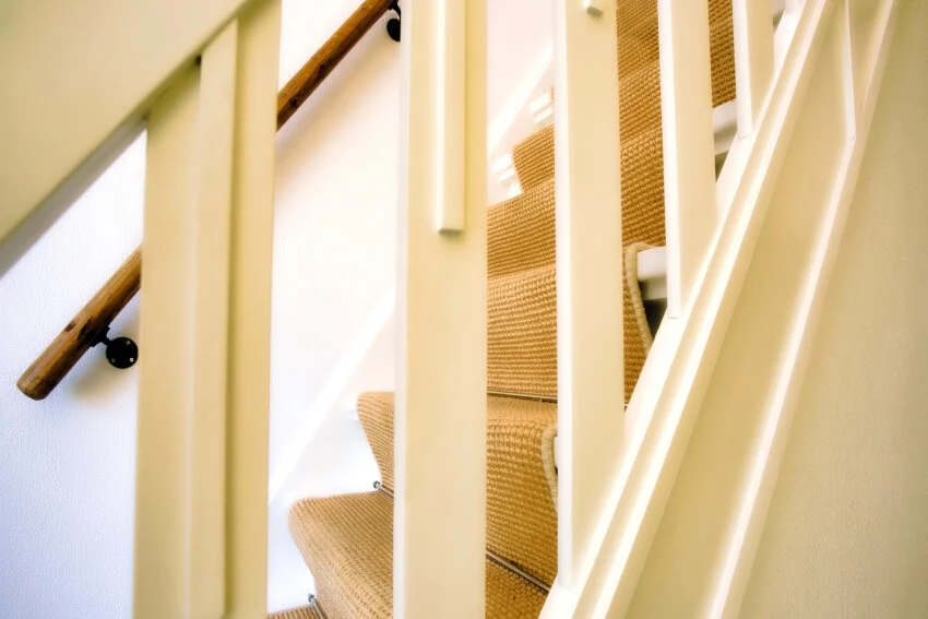 Close-up of a white stairs with polypropylene runner