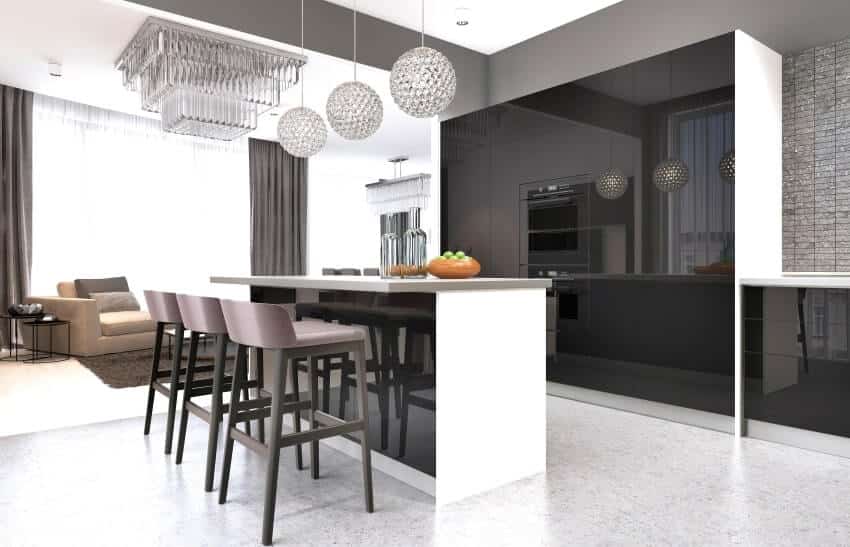 Contemporary kitchen with a black glossy cabinets, an island, and crystal pendant lights and chandelier