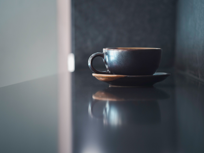 Cup on ceramic coaster in kitchen