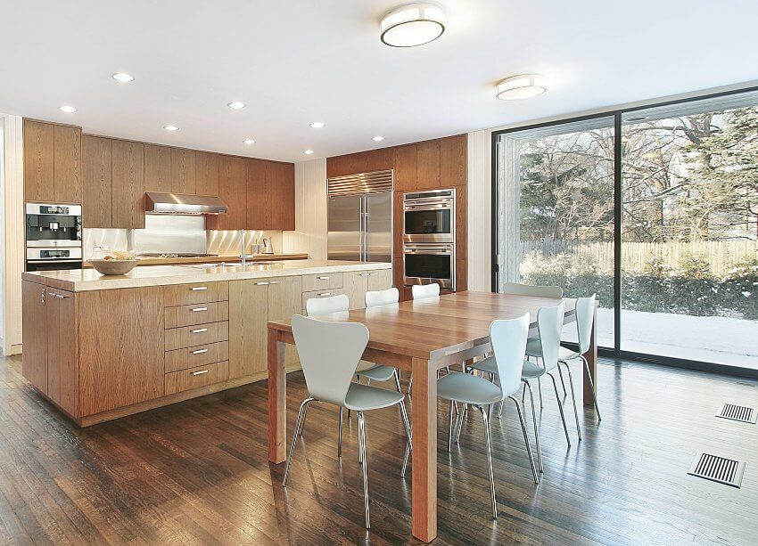 Dining area and kitchen with wood floors, laminate cabinets, panorama windows, and large island