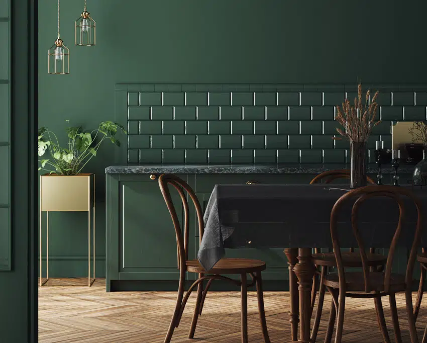 Dining area with green marble countertop, table, chairs, wood floor, and tile backsplash