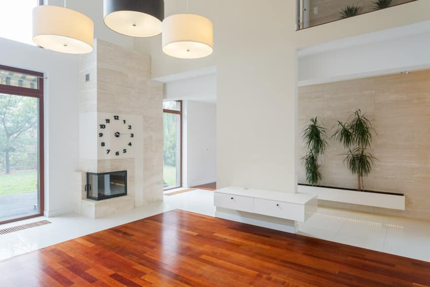 Empty space with lighting fixtures and mahogany floors