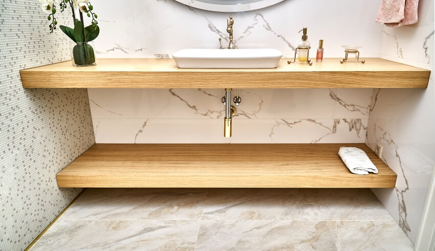 Floating butcher block basin countertops with white ceramic sink in contemporary apartment bathroom