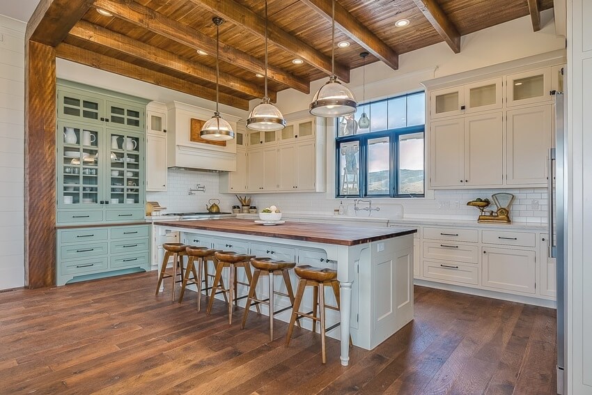 Gorgeous kitchen interior with wooden accents, white walls, and redwood countertop island