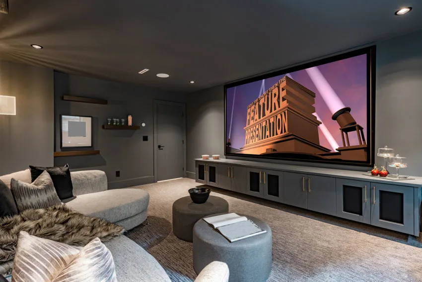 Home theater room with couch, television, and ceiling lights