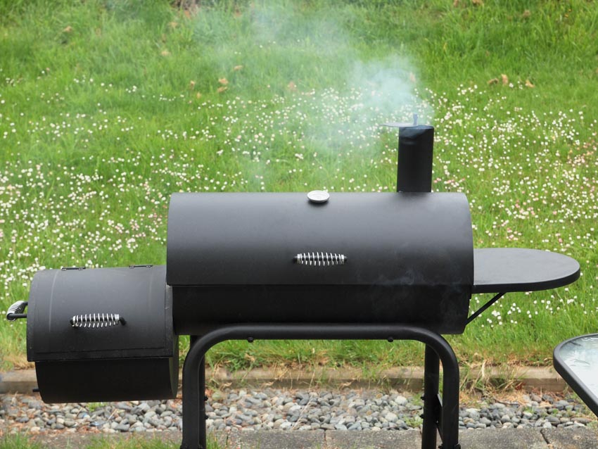 Horizontal smoker grill with small platform on the side