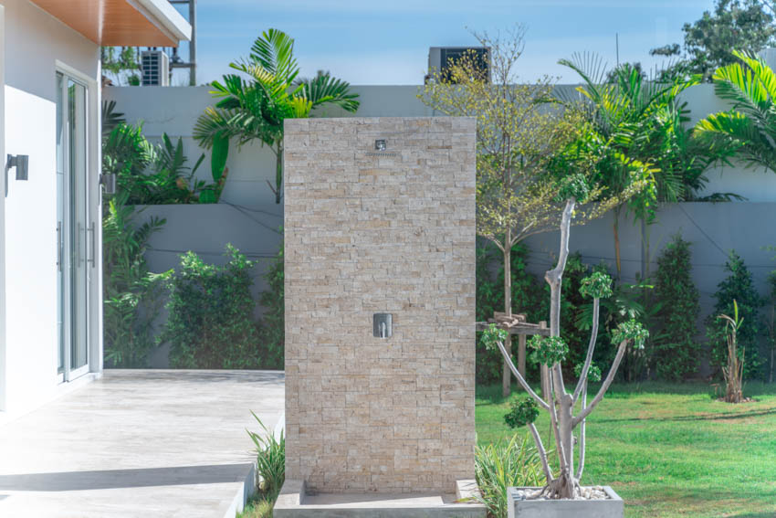 Minimalist shower soace with beigge brick walls